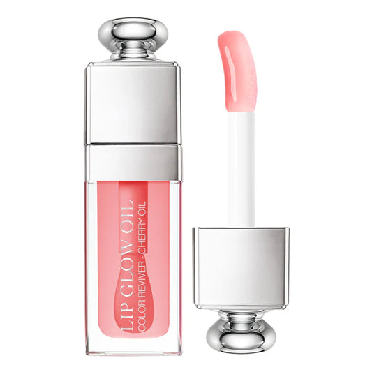 Lip glow oil with applicator on a white background