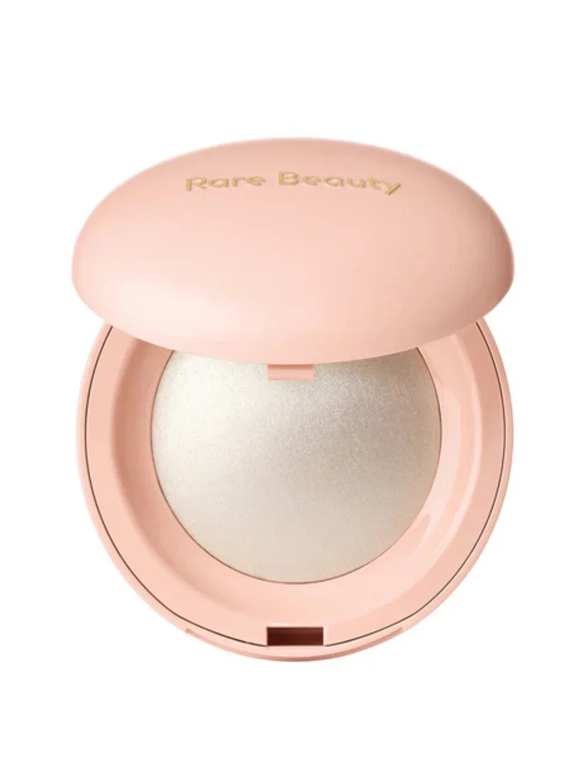 Compact powder with a lid featuring 'Rare Beauty' on a white background