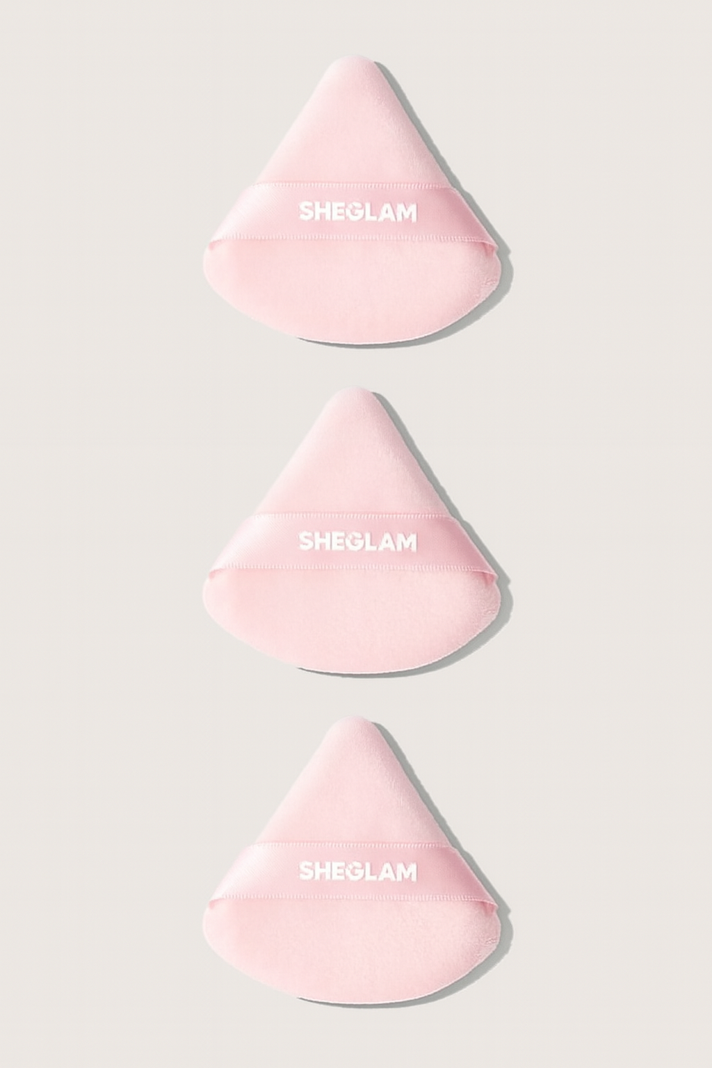 Three pink silicone sponges with 'SHEOLAM' branding on a light gray background