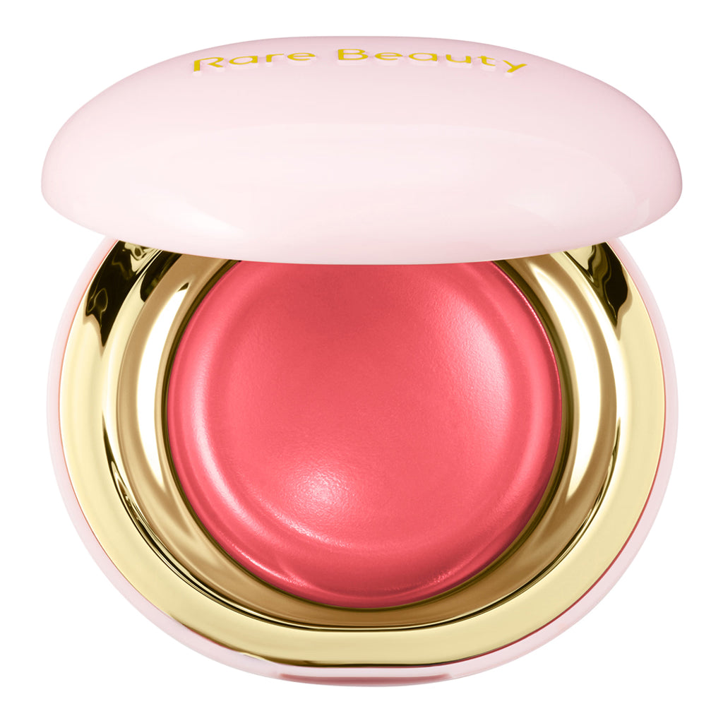 Pink blush in a gold and pink compact case with 'Rare Beauty' branding.